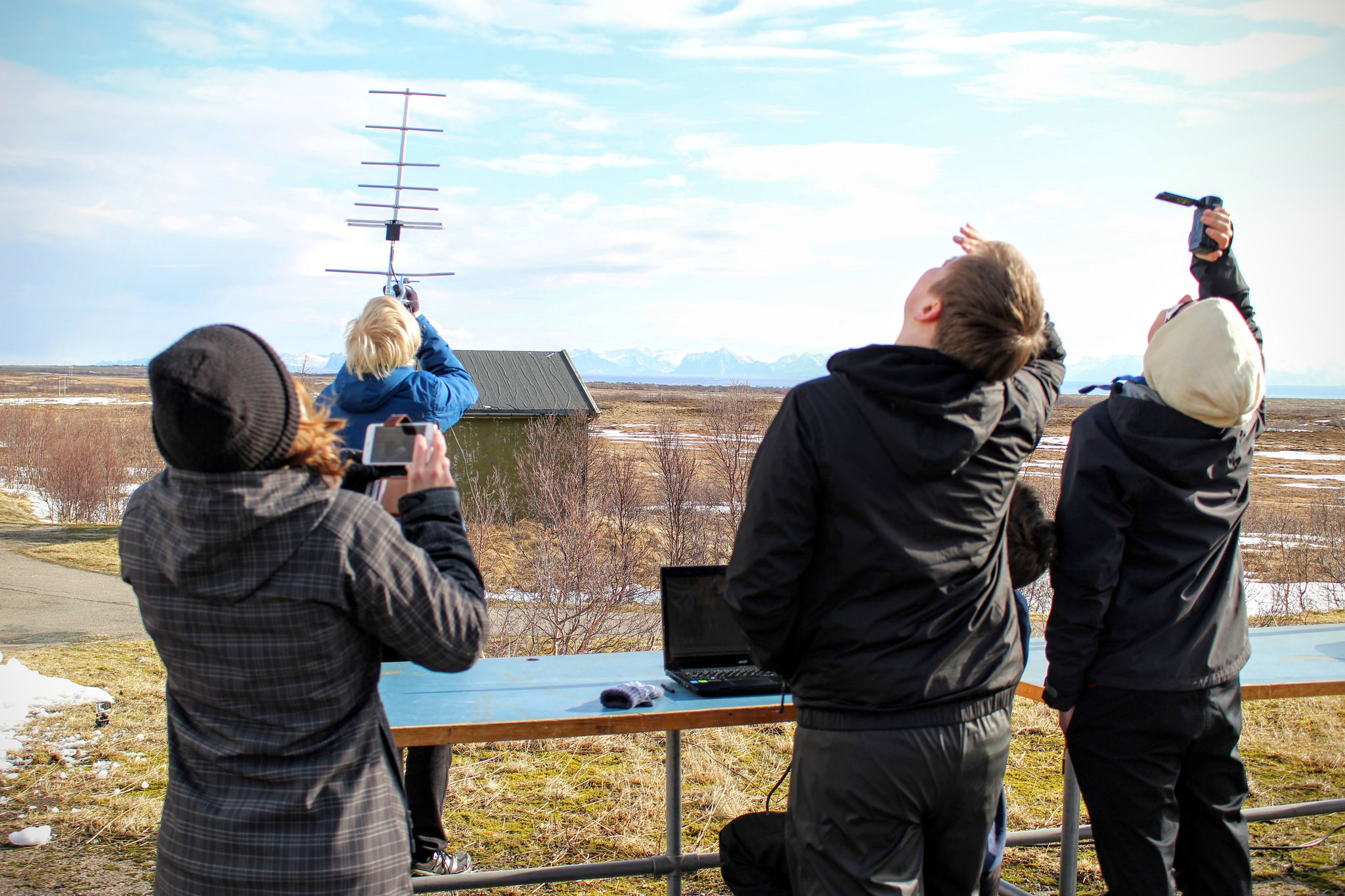 Students follow their descending CanSat while they receive radio signals from their CanSat via an antenna